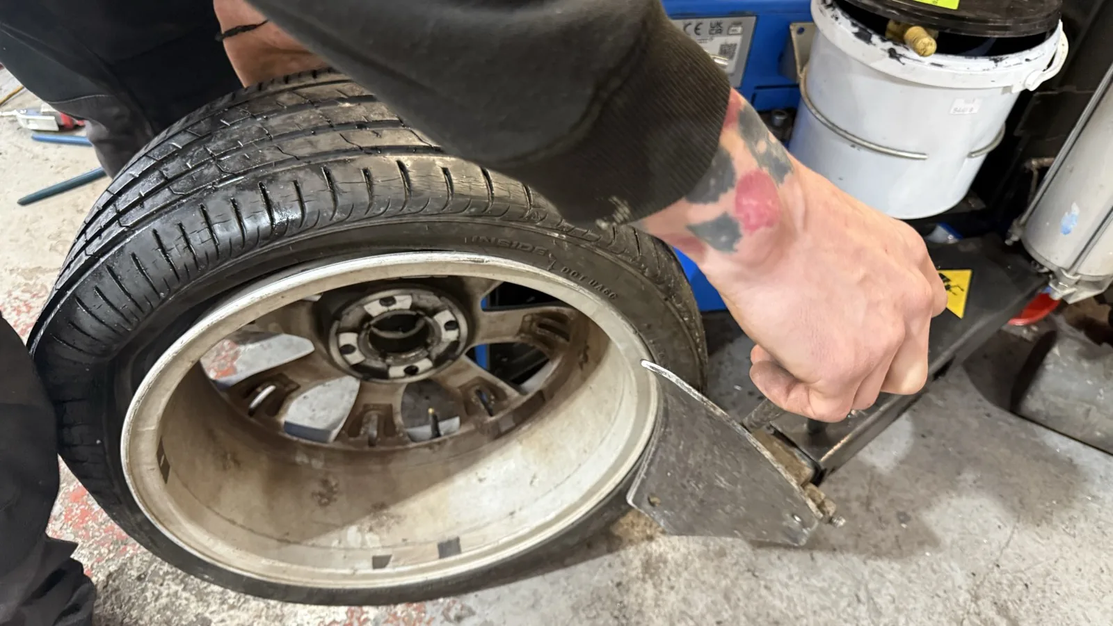 YourNewTyres fitter changing a tyre on a customer's driveway